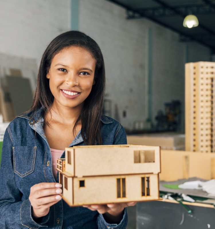 smiling-african-american-woman-with-model-house